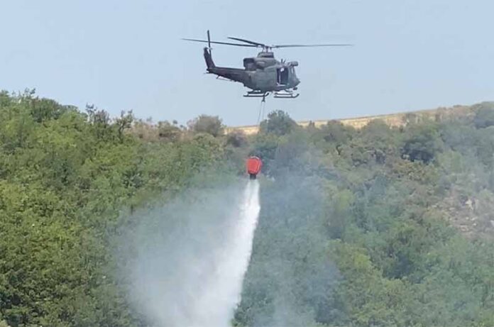 Un HH-412 mentre lancia l'acqua