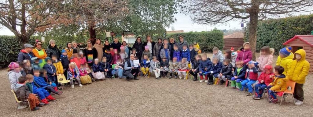 I bambini consegnano la targa a Giuseppe Paolocci